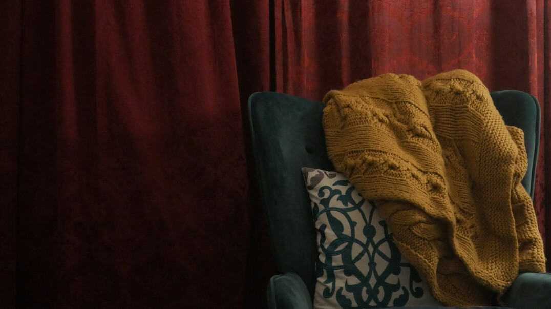 Seniors watching a film together in a cozy room with blankets