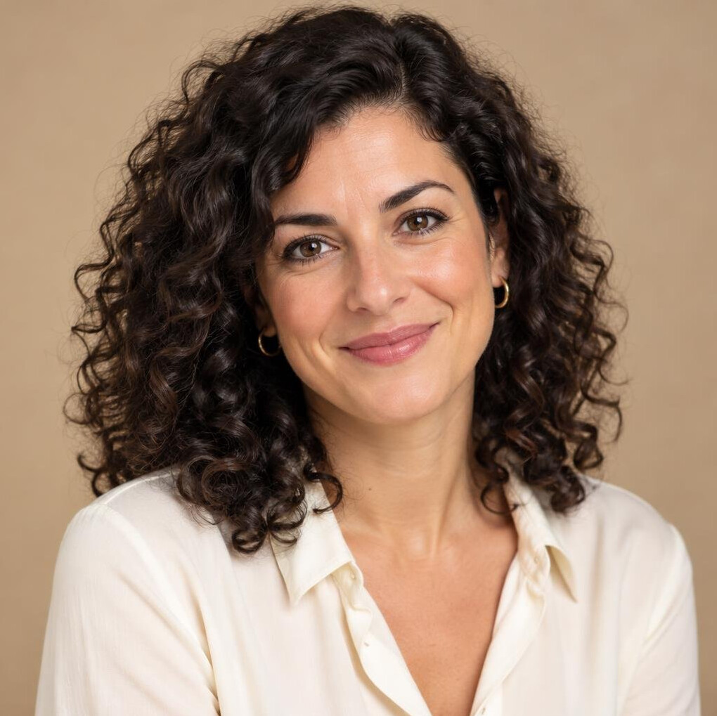 Portrait of a kind young woman with curly dark hair