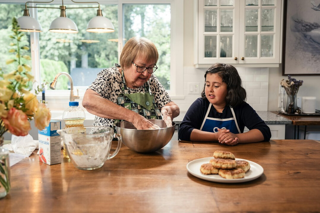 Elderly people cooking together in a community kitchen