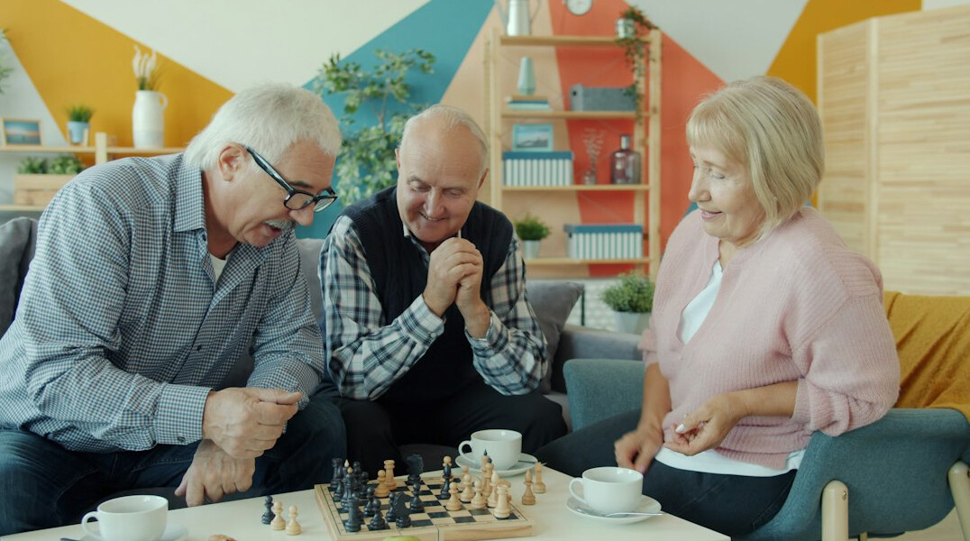 seniors playing cards in community room