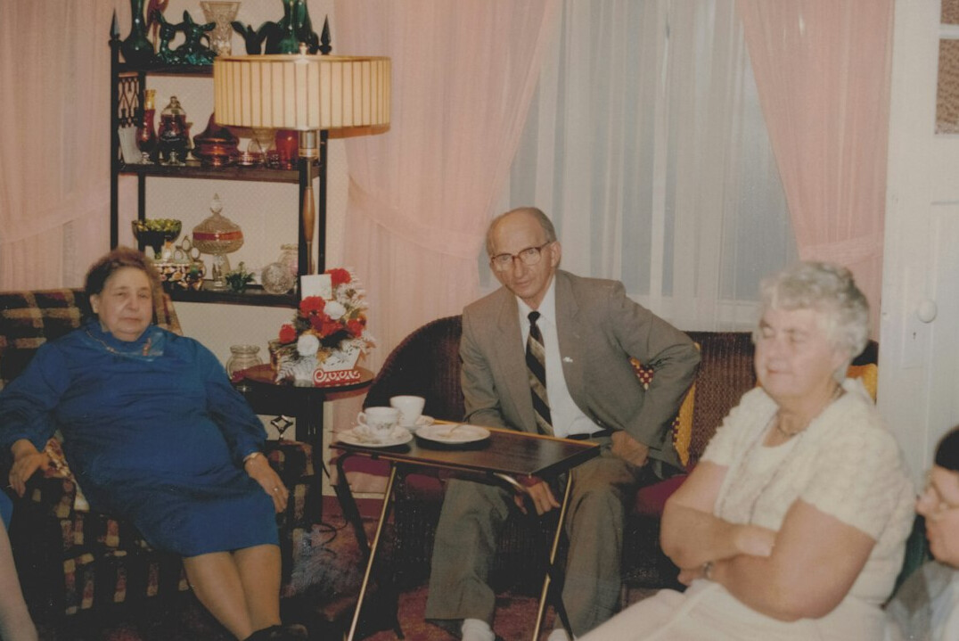 Elderly book club members discussing a novel with tea