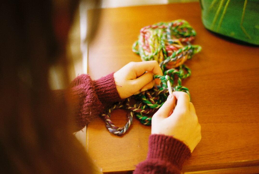 Elderly women knitting and doing handicrafts at a table